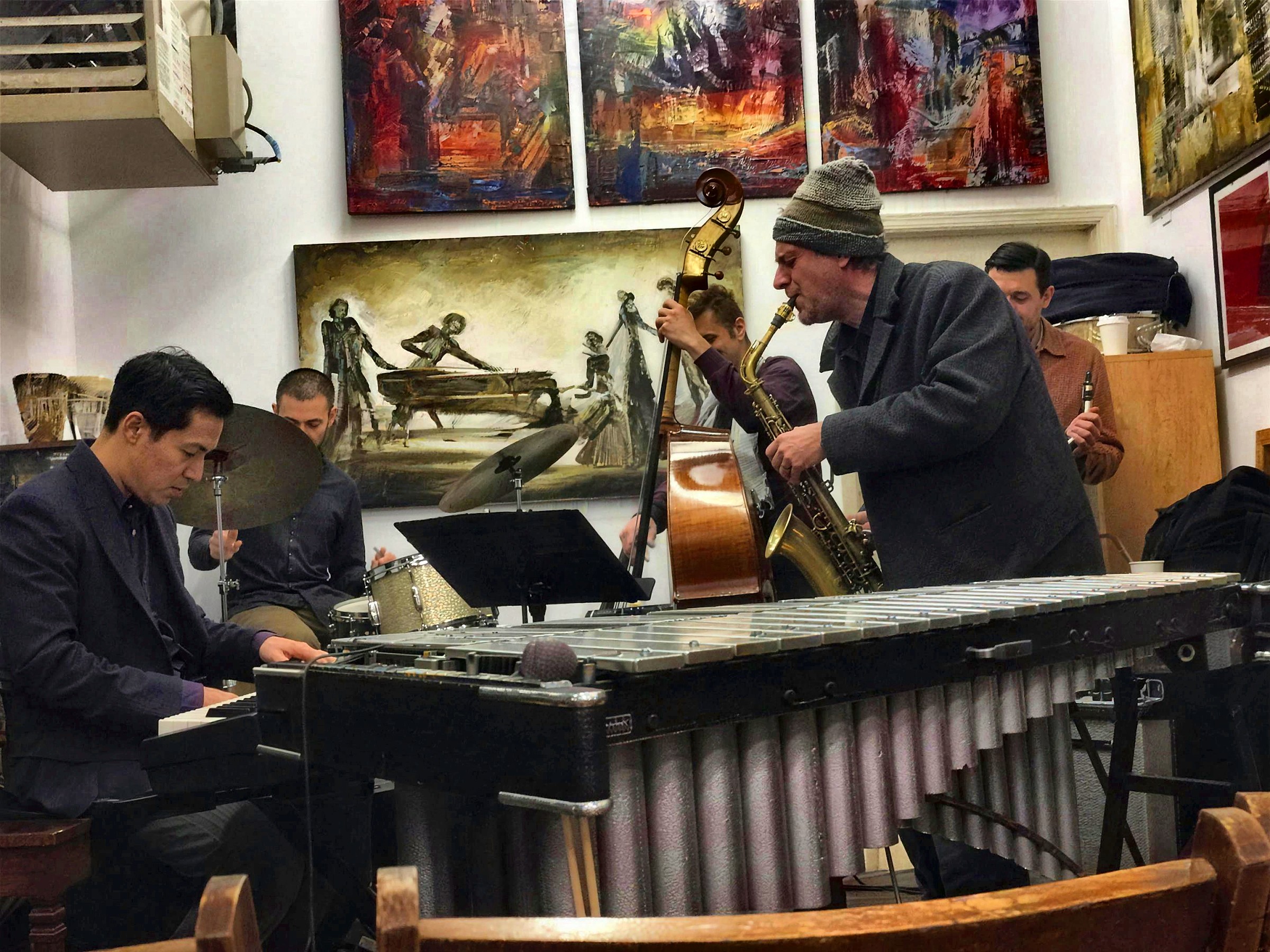 Dan leaning into the baritone over the vibraphone, gallery walls behind