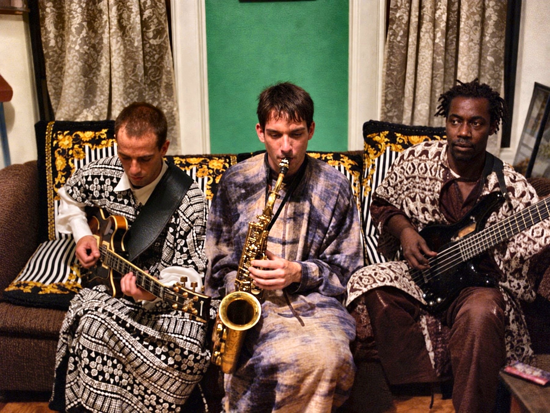 Dan Magay playing saxophone between two other musicians